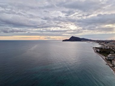 Gün batımını deniz yoluyla sakinleştirir, günbatımında sakin okyanus manzarası siluetler ve yansıtıcı sularla