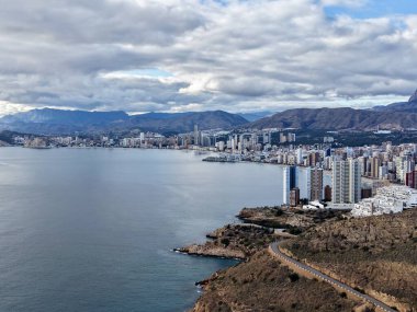 Altın saat kıyı şeridi ve uçurum boyunca kıvrımlı bir yol parlayan körfez ve binaların üzerine sıcak bir ışık.,