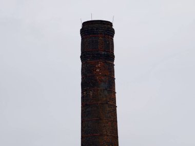 Kapalı tuğla baca üstü, dar çerçeve, çatlamış tuğla yüzlü kurum izlerini ortaya çıkarıyor.