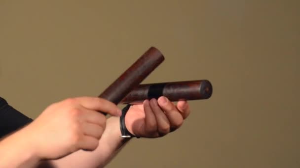 One Man Playing on the Percussion Instrument Claves. on the Bright Walls Background. — Stock Video