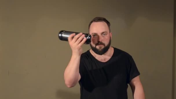 One Man With a Beard in Black T-Shirt, Playing on the Percussion Instrument Bells. sullo sfondo delle mura luminose . — Video Stock