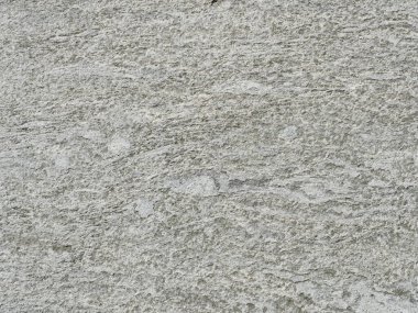 Gri tonlu granit gibi bir yüzey. Kaba dokusu ve daha açık renkleri var. Özgeçmiş ve metin alanı için uygun. Yakın plan. Kopyalama alanı.