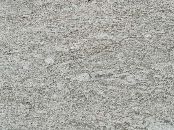 Gri tonlu granit gibi bir yüzey. Kaba dokusu ve daha açık renkleri var. Özgeçmiş ve metin alanı için uygun. Yakın plan. Kopyalama alanı.