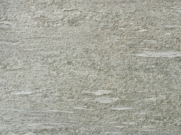Gri tonlu granit gibi bir yüzey. Kaba dokusu ve daha açık renkleri var. Özgeçmiş ve metin alanı için uygun. Yakın plan. Kopyalama alanı.
