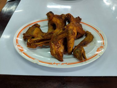 several pieces of fried chicken on a white plate