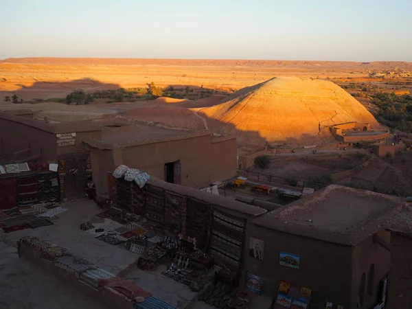 Ait Ben Haddou 'nun Arap Çarı' nda günbatımı: geleneksel bir Fas pazarı ve dağlık bir manzara. Fas 'a Seyahat.
