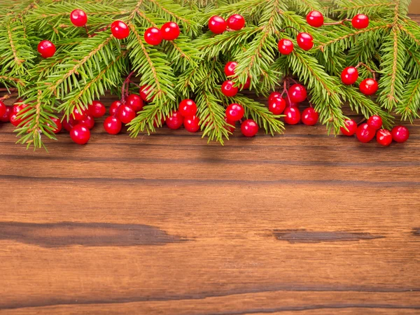 Vánoční strom a červené bobule na tmavém pozadí — Stock fotografie