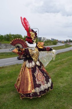 Sophisticated Baroque Lady in Maroon and Gold Embroidery with Luxury Ornate Fan.