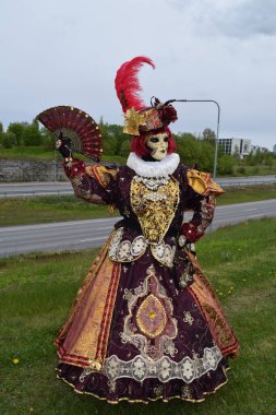 Sophisticated Baroque Lady in Maroon and Gold Embroidery with Luxury Ornate Fan.