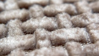 Yoğun tekstil kumaşının detaylı bir makro fotoğrafı, ipliklerin ve yapılarının iç içe geçişini gösteriyor..