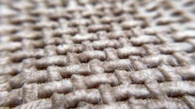 Yumuşak bir kumaşın yakın çekimi, dokusu ve liflerin üç boyutlu yapısını vurguluyor. Arkaplan ve tasarım için soyut bir resim.