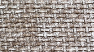 Yumuşak bir kumaşın yakın çekimi, dokusunu ve dokusunu vurguluyor. Arkaplan ve tasarım için soyut bir resim.