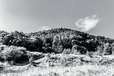 black and white clouds over mountains landscape.