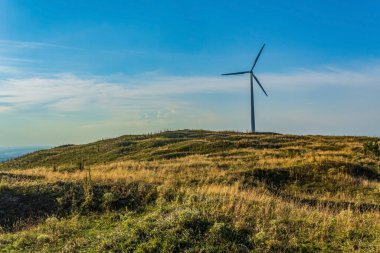 green turbines in the mountains. alternative energy concept. alternative electricity source.