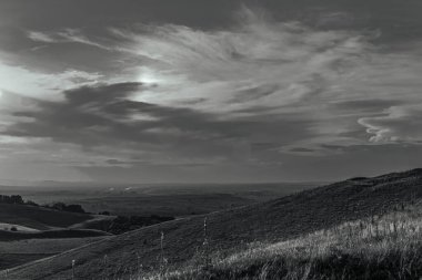 a black and white landscape with a beautiful landscape in the countryside in the background