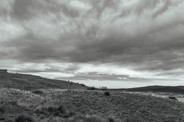 a vertical shot of the landscape with a cloudy day in the mountains