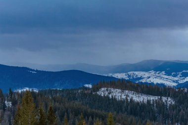 snow - covered mountain peaks in the winter mountains