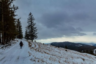 winter mountain road with a backpack