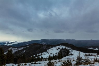 winter landscape with snow covered mountains in the evening