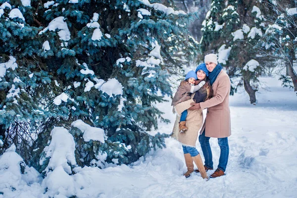 Portrait of a family against the background of snow-covered trees — Photo