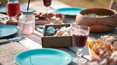 Bahçede tabaklar ve yiyeceklerle şenlikli ahşap masa servis edildi.