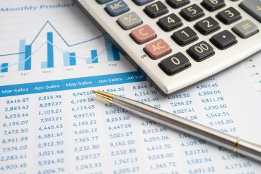 Veri iş grafikleri kağıdında kalemle hesap makinesi.