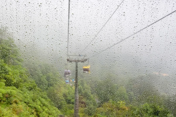 water drop foreground with cable car scene in the background, genting, Malaysia