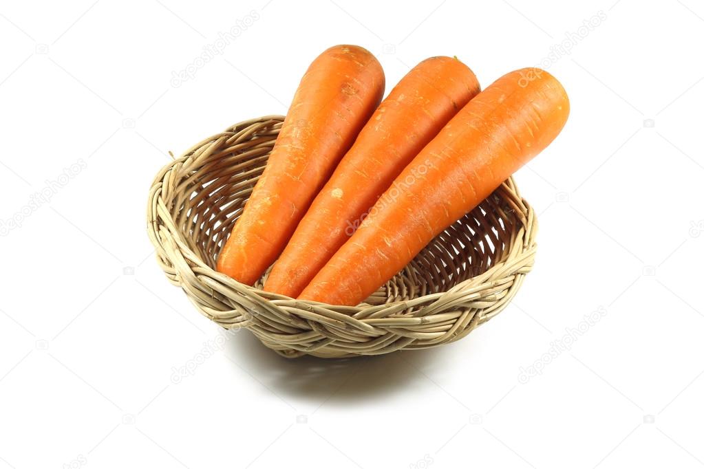 Isolated carrot in a wooden basket on white background with clipping path