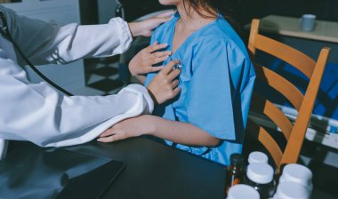healthy concept; Doctor checking patient's heart with stethoscope at a hospital