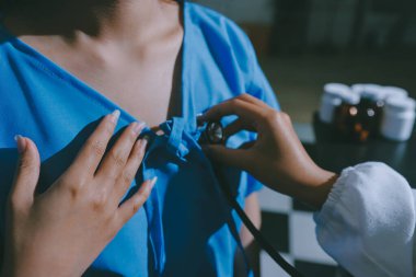 healthy concept; Doctor checking patient's heart with stethoscope at a hospital