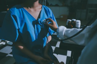 healthy concept; Doctor checking patient's heart with stethoscope at a hospital
