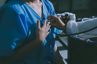 healthy concept; Doctor checking patient's heart with stethoscope at a hospital