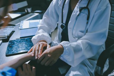Male doctors shake hands with patients encouraging each other and praying for blessings. To offer love, concern, and encouragement while checking the patient's health. concept of medicine