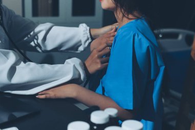healthy concept; Doctor checking patient's heart with stethoscope at a hospital