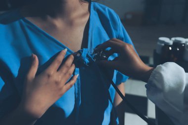 healthy concept; Doctor checking patient's heart with stethoscope at a hospital