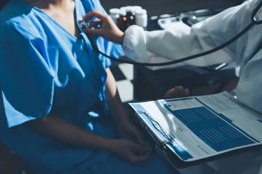 healthy concept; Doctor checking patient's heart with stethoscope at a hospital