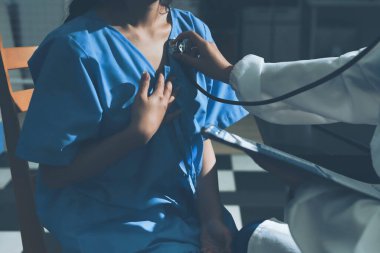 healthy concept; Doctor checking patient's heart with stethoscope at a hospital
