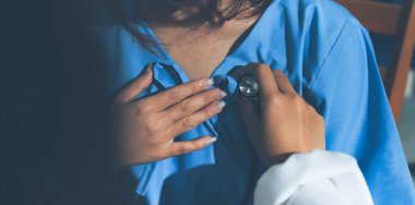 healthy concept; Doctor checking patient's heart with stethoscope at a hospital
