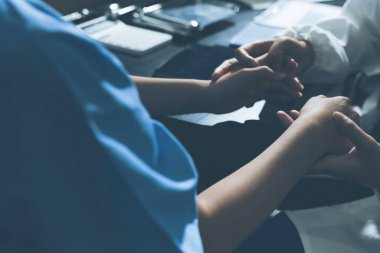 Male doctors shake hands with patients encouraging each other and praying for blessings. To offer love, concern, and encouragement while checking the patient's health. concept of medicine