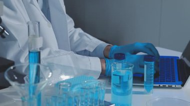 Laboratuarda mikroskop kullanan bir bilim adamı..