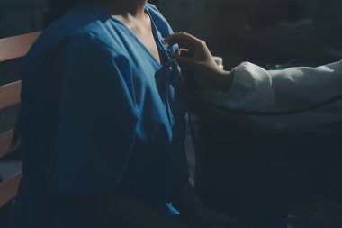 healthy concept; Doctor checking patient's heart with stethoscope at a hospital
