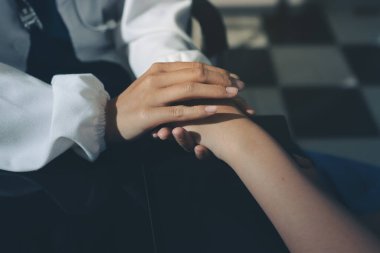 Male doctors shake hands with patients encouraging each other and praying for blessings. To offer love, concern, and encouragement while checking the patient's health. concept of medicine