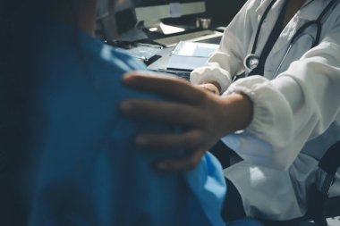 Male doctors shake hands with patients encouraging each other and praying for blessings. To offer love, concern, and encouragement while checking the patient's health. concept of medicine