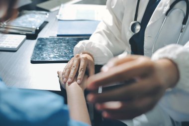 Male doctors shake hands with patients encouraging each other and praying for blessings. To offer love, concern, and encouragement while checking the patient's health. concept of medicine