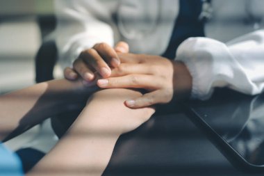 Male doctors shake hands with patients encouraging each other and praying for blessings. To offer love, concern, and encouragement while checking the patient's health. concept of medicine