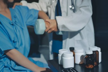 Fizyoterapist, halter egzersizinde bir kadına yardım ediyor.