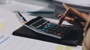 İş adamı hesap makinesiyle mali hesaplama hesaplıyor