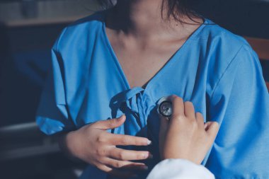 healthy concept; Doctor checking patient's heart with stethoscope at a hospital