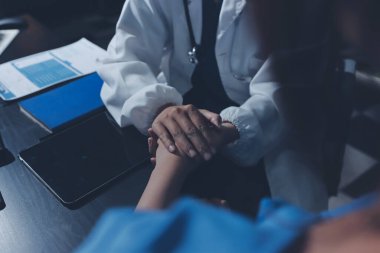 Male doctors shake hands with patients encouraging each other and praying for blessings. To offer love, concern, and encouragement while checking the patient's health. concept of medicine