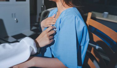 healthy concept; Doctor checking patient's heart with stethoscope at a hospital